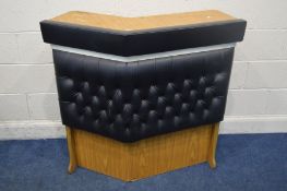 AN MID TO LATE 20TH CENTURY ANGLED DRINKS BAR, with buttoned black leatherette padded front, width