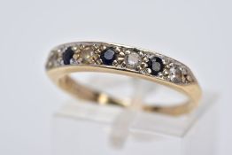 A 9CT GOLD SAPPHIRE AND CUBIC ZIRCONIA HALF HOOP RING, designed with a row of three circular cut