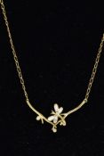 A MODERN DIAMOND PENDANT STYLED AS A DRAGONFLY BETWEEN BRANCHES, fitted in a fixed position to a