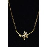A MODERN DIAMOND PENDANT STYLED AS A DRAGONFLY BETWEEN BRANCHES, fitted in a fixed position to a