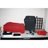 A SAMSONITE RED SUITCASE, a black suitcase, a boxed Magrit handbag, a Clarins Toilet bag , a