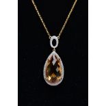 AN 18CT GOLD CITRINE AND DIAMOND PENDANT NECKLET, designed with a claw set pear cut citrine,