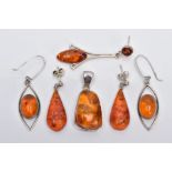 A COLLECTION OF MODERN AMBER JEWELLERY, to include an abstract shaped pendant, two pairs of drop