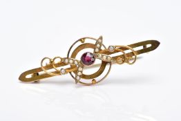 AN EARLY 20TH CENTURY GARNET AND SPLIT PEARL BAR BROOCH with scroll and foliate detail, stamped '
