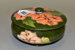 A MOORCROFT POTTERY POWDER BOWL AND COVER, 'Coral Hibiscus' pattern on green ground, Queen Mary