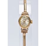 A LADIES 9CT GOLD ACCURIST WRISTWATCH, oval silver dial signed 'Accurist 21 jewels', baton markers