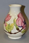 A MOORCROFT 'PINK MAGNOLIA' baluster shaped vase with impressed and painted backstamps, date