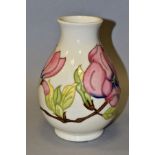 A MOORCROFT 'PINK MAGNOLIA' baluster shaped vase with impressed and painted backstamps, date