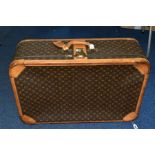 A LOUIS VUITTON MONOGRAM SUITCASE IN POOR CONDITION, tan leather trim, combination lock (locked,