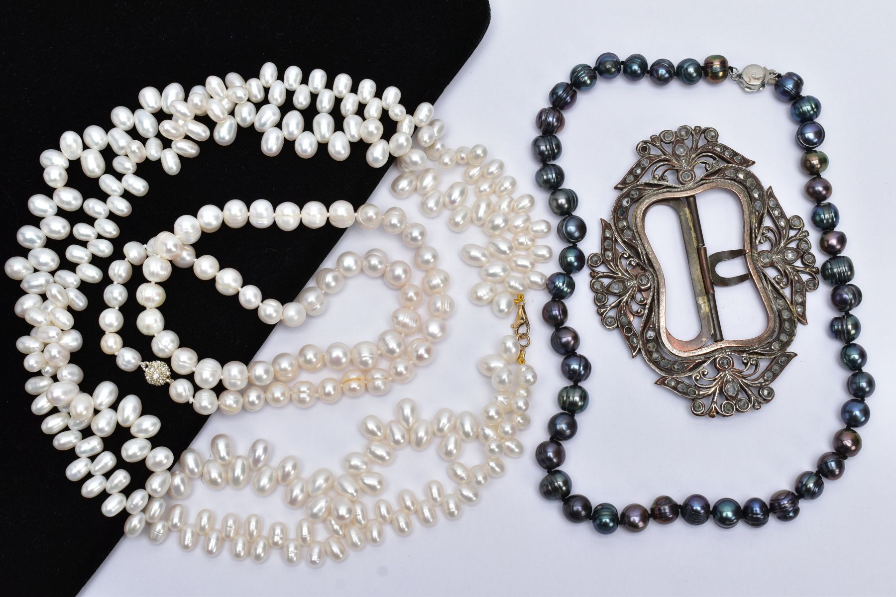 TWO CULTURED FRESHWATER PEARL NECKLACES, A TAHITIAN PEARL NECKLACE AND A WHITE METAL BUCKLE, the