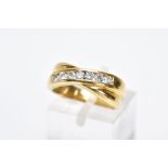 AN 18CT GOLD DIAMOND RING, of a crossover design, set with a row of channel set round brilliant