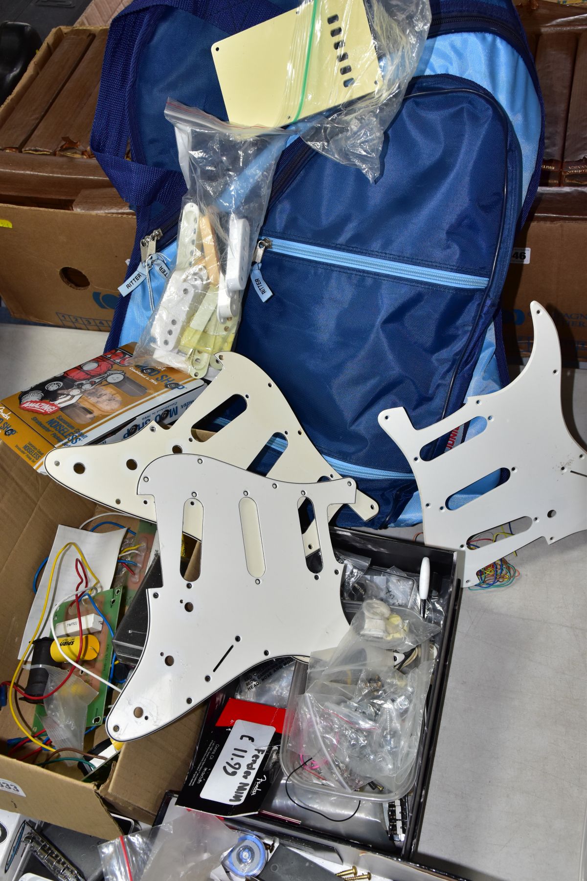 THREE TRAYS CONTAINING GUITAR PARTS, including a 1980 Strat tremolo, 3 scratchplates, a packaged - Image 6 of 6