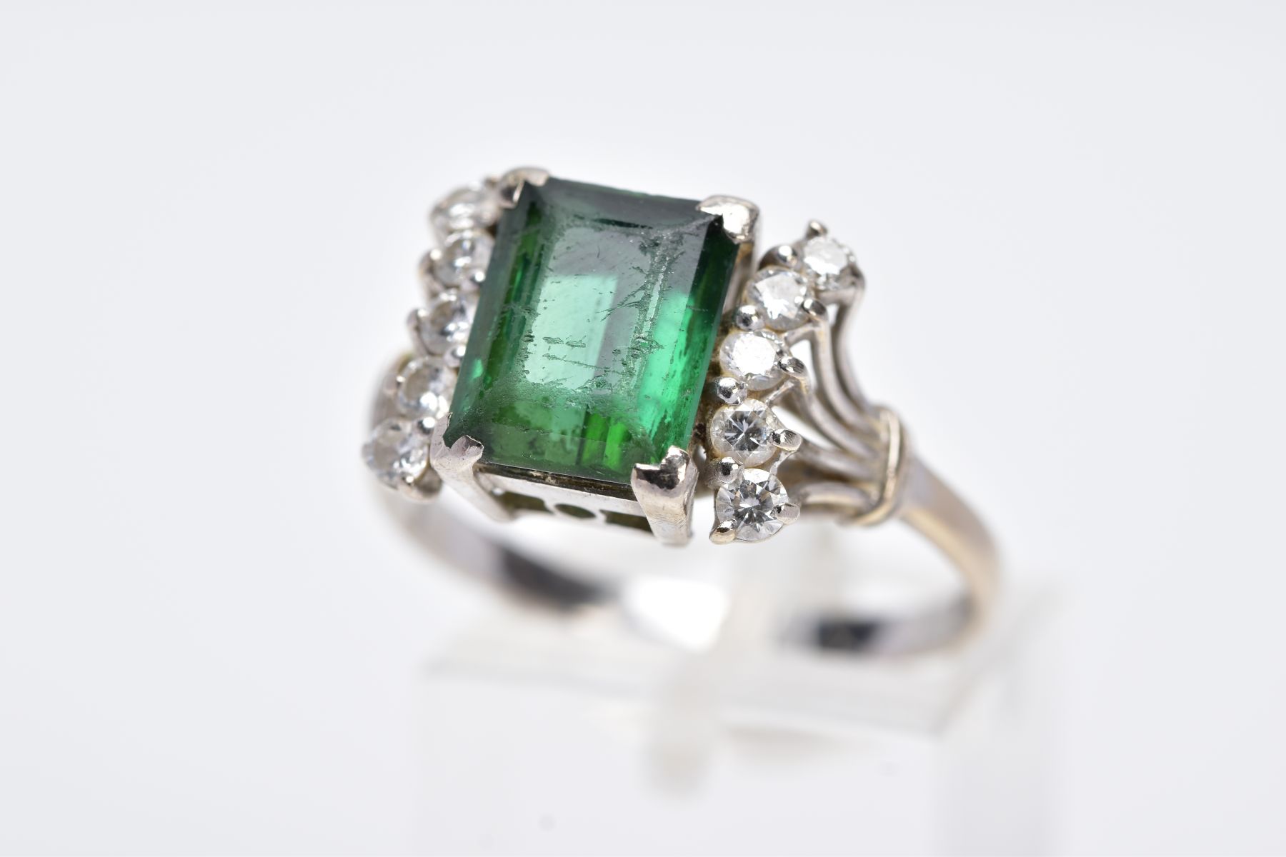 AN 18CT WHITE GOLD GREEN TOURMALINE AND DIAMOND RING, designed with a central, rectangular cut green