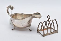 A SILVER SAUCE BOAT AND TOAST RACK, the Georgian sauce boat of a plain polished design, scallop