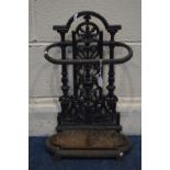 A BLACK PAINTED CAST IRON UMBRELLA STAND with a separate tray