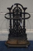 A BLACK PAINTED CAST IRON UMBRELLA STAND with a separate tray