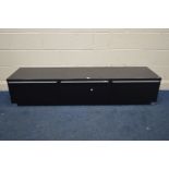 A MODERN BLACK FINISH TV STAND, with two deep drawer flanking a fall front door, width 180cm x depth