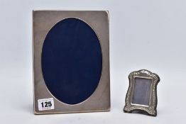 TWO SILVER FRAMES, the first of a plain polished rectangular form, with an oval aperture, hallmarked