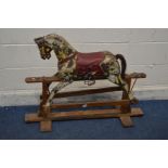 AN EARLY 20TH CENTURY DAPPELED ROCKING HORSE, unsigned, with leather bridle and horse hair tail on a