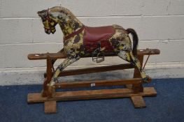 AN EARLY 20TH CENTURY DAPPELED ROCKING HORSE, unsigned, with leather bridle and horse hair tail on a