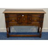 A TITCHMARSH AND GOODWIN JACOBEAN STYLE LOW OAK TWO DOOR CREDENCE CABINET, on turned front legs