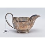 A GEORGE V SILVER GRAVY BOAT, of a plain polished wavy edge design, tapered handle, on a raised