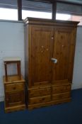 A PINE TWO DOOR WARDROBE, above four drawers, width 120cm x depth 54cm x height 200cm and a matching
