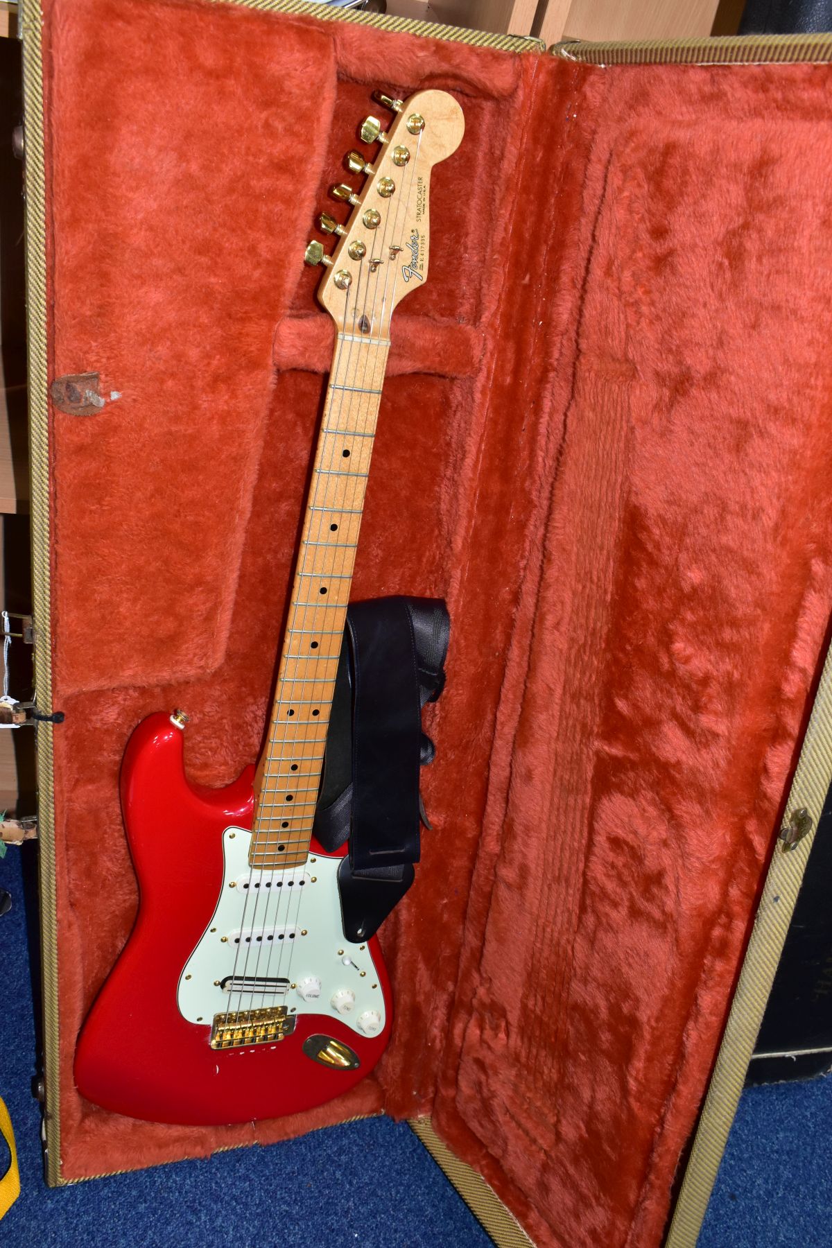 A 1984 USA FENDER STRATOCASTER GUITAR, in red with a one piece maple neck and fingerboard, gold
