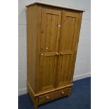 A MODERN PINE TWO DOOR WARDROBE, over a single drawer, width 89cm x depth 55cm x height 184cm