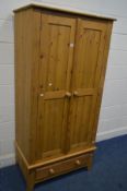 A MODERN PINE TWO DOOR WARDROBE, over a single drawer, width 89cm x depth 55cm x height 184cm
