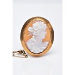 A YELLOW METAL CAMEO BROOCH, of an oval design depicting a lady in profile within a collet mount and