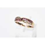 A 9CT GOLD RUBY AND DIAMOND RING, of an interlinking crossover design, set with a row of channel set