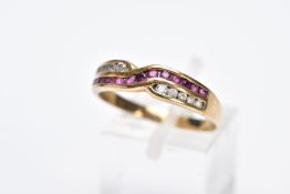 A 9CT GOLD RUBY AND DIAMOND RING, of an interlinking crossover design, set with a row of channel set