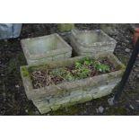 A COMPOSITE BRICK EFFECT PLANTER (crack to corner) width 67cm x depth 28cm x height 27cm together