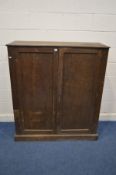 AN EARLY TO MID 20TH CENTURY OAK PANELLED TWO DOOR CUPBOARD, width 122cm x depth 45cm x height 137cm