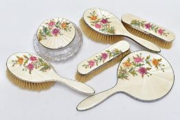 A SILVER AND GUILLOCHE ENAMEL VANITY SET, to include two hairbrushes, a handheld mirror, two clothes