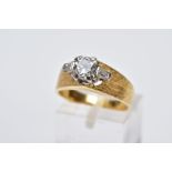 A SINGLE STONE DIAMOND RING, the yellow metal ring set with a raised claw set, round brilliant cut