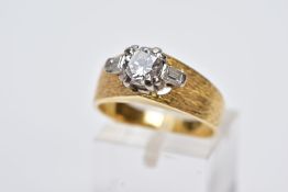 A SINGLE STONE DIAMOND RING, the yellow metal ring set with a raised claw set, round brilliant cut