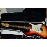 A 2000 USA FENDER STRATOCASTER in cherry sunburst with a maple neck, rosewood fingerboard,