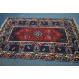 A CAUSCASION KAZAK RUG, with blue and red field, 234cm x 129cm
