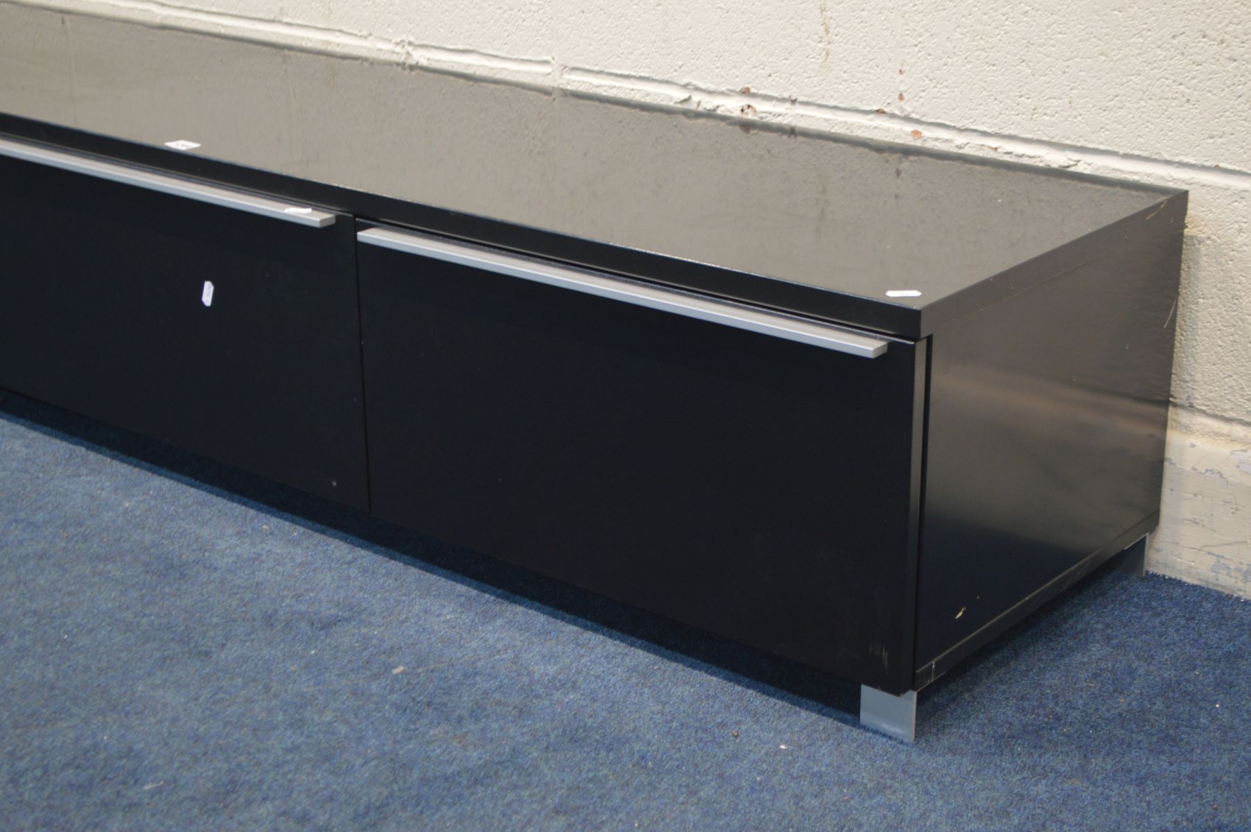 A MODERN BLACK FINISH TV STAND, with two deep drawer flanking a fall front door, width 180cm x depth - Image 2 of 3