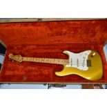 AN EARLY 1980'S USA FENDER STRATOCASTER GOLD ON GOLD, serial no CA11522, on a one piece maple neck