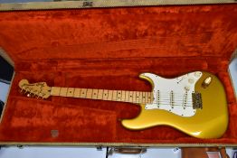 AN EARLY 1980'S USA FENDER STRATOCASTER GOLD ON GOLD, serial no CA11522, on a one piece maple neck