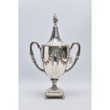 A GEORGE III SILVER TROPHY CUP, of a plain polished design, embossed foliate swag with an engraved