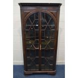 A GEORGIAN MAHOGANY ASTRAGAL GLAZED TWO DOOR FLOORSTANDING CORNER CUPBOARD, with four fixed shelves,