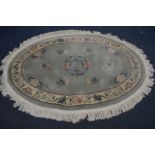 AN PALE GREEN OVAL WOLLEN CHINESE RUG, 194cm x 132cm