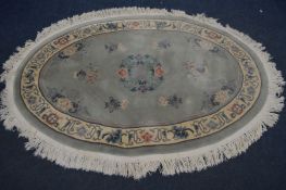 AN PALE GREEN OVAL WOLLEN CHINESE RUG, 194cm x 132cm