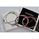 FOUR PANDORA CHARM BRACELETS, to include a snake bracelet fitted with a triangular charm with the