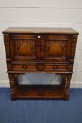 A TITCHMARSH AND GOODWIN JACOBEAN STYLE OAK TWO DOOR CREDENCE CUPBOARD, above two drawers, on turned