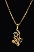 A YELLOW METAL SAPPHIRE AND DIAMOND PENDANT NECKLET, the pendant of a floral design set with two